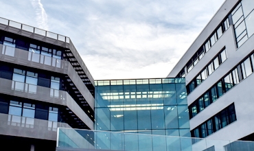 A clock tower on a majestic building, standing tall against the blue sky.