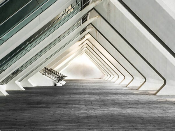 A long hallway with a bench in the middle, providing a resting spot for people in transit.