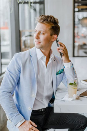 A man in a blue jacket talking on his cell phone.